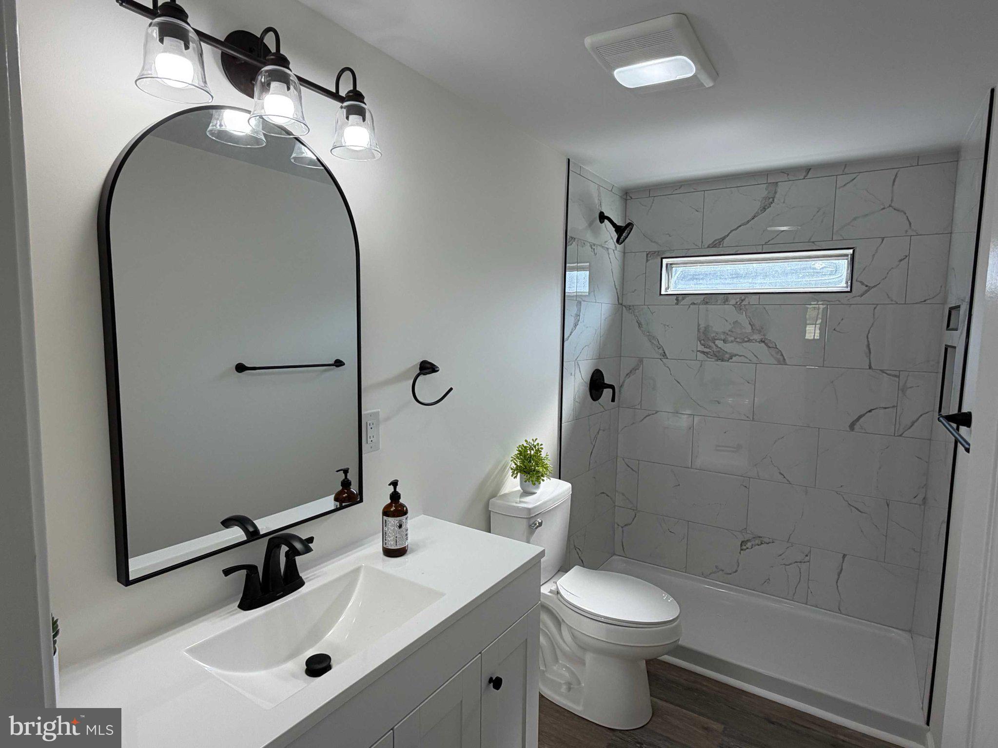 17335 Isdell Road Milford, DE 19963 - Photo 18 of 18 a bathroom with a sink toilet and shower