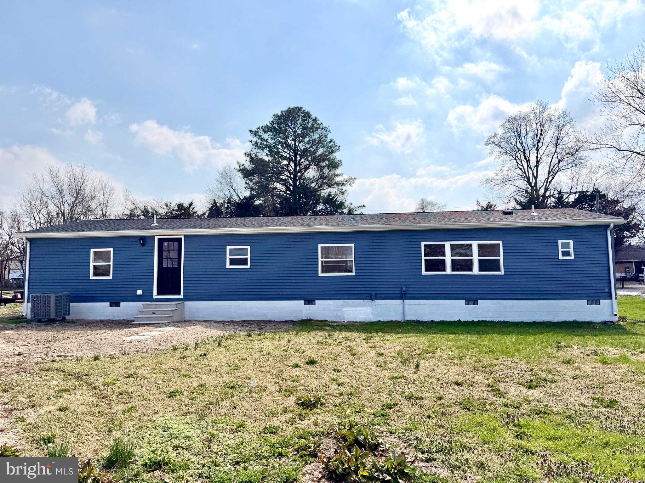 17335 Isdell Road Milford, DE 19963 - Photo 5 of 18 a house with trees in the background