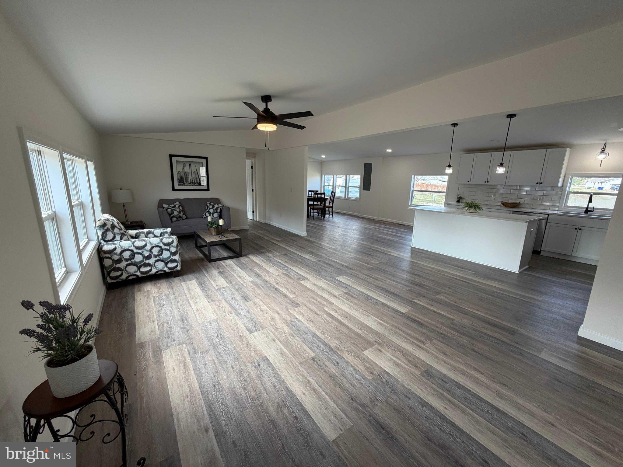17335 Isdell Road Milford, DE 19963 - Photo 6 of 18 a living room with furniture and wooden floor