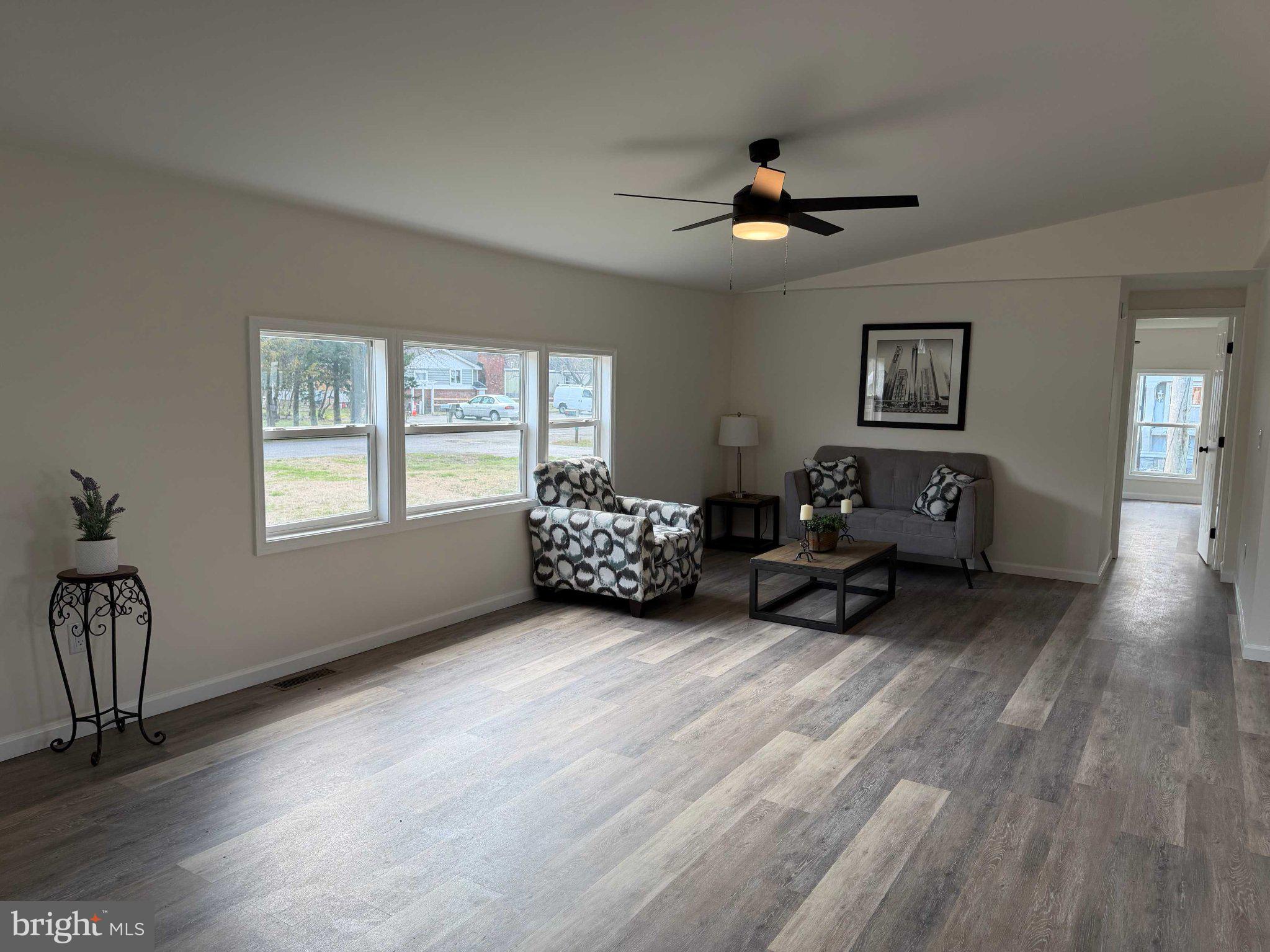 17335 Isdell Road Milford, DE 19963 - Photo 7 of 18 a living room with furniture and a window