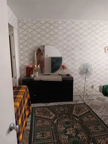 a bedroom with two beds and a window