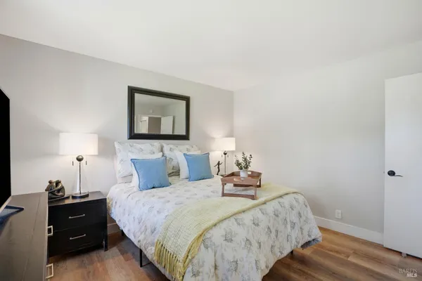 a bedroom with a bed and wooden floor