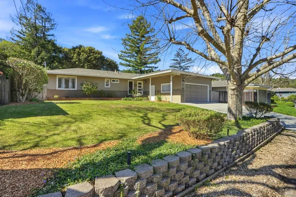 a front view of house with yard and green space
