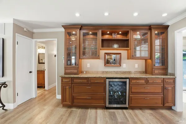a spacious bathroom with a granite countertop sink and a large mirror