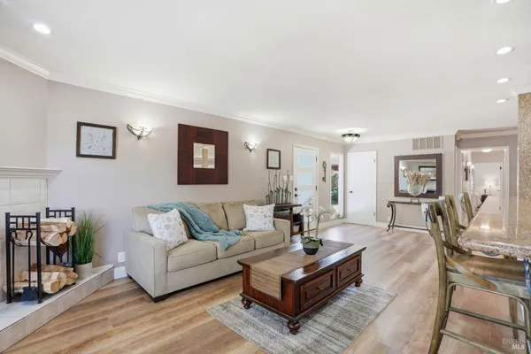 a living room with furniture and wooden floor