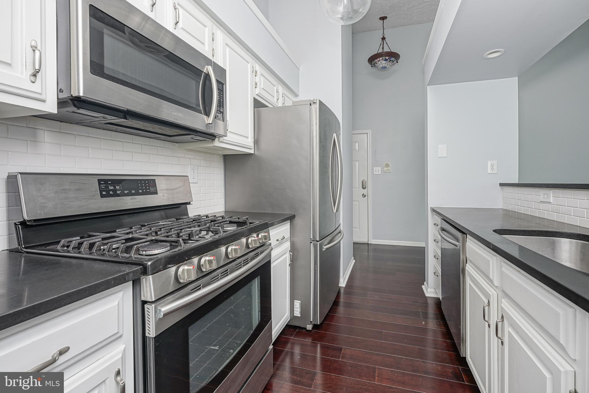 84 Eldon Way Marlton, NJ 08053 - Photo 12 of 27 a kitchen with stainless steel appliances a stove a microwave and a sink