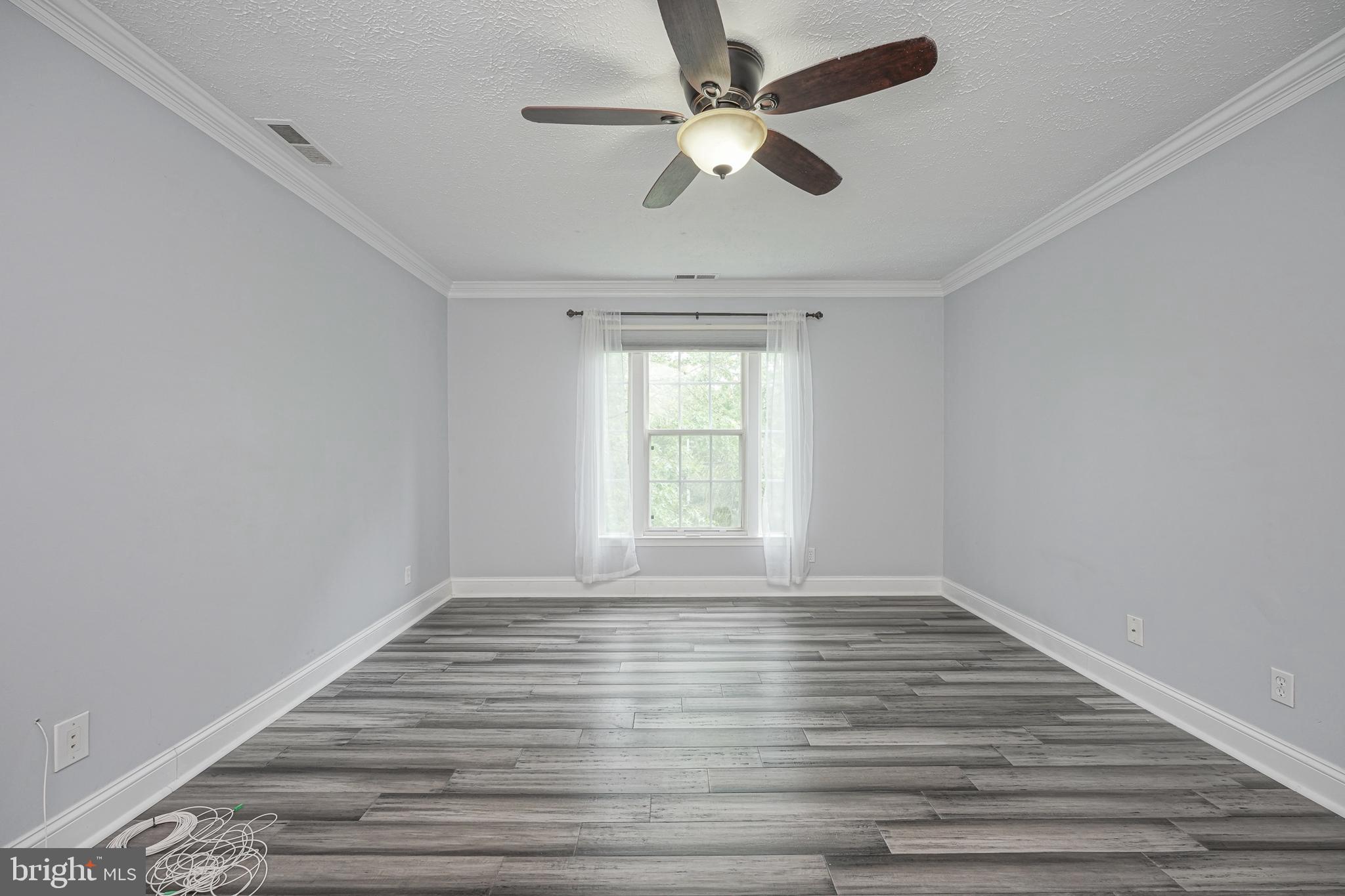 84 Eldon Way Marlton, NJ 08053 - Photo 14 of 27 an empty room with wooden floor and windows