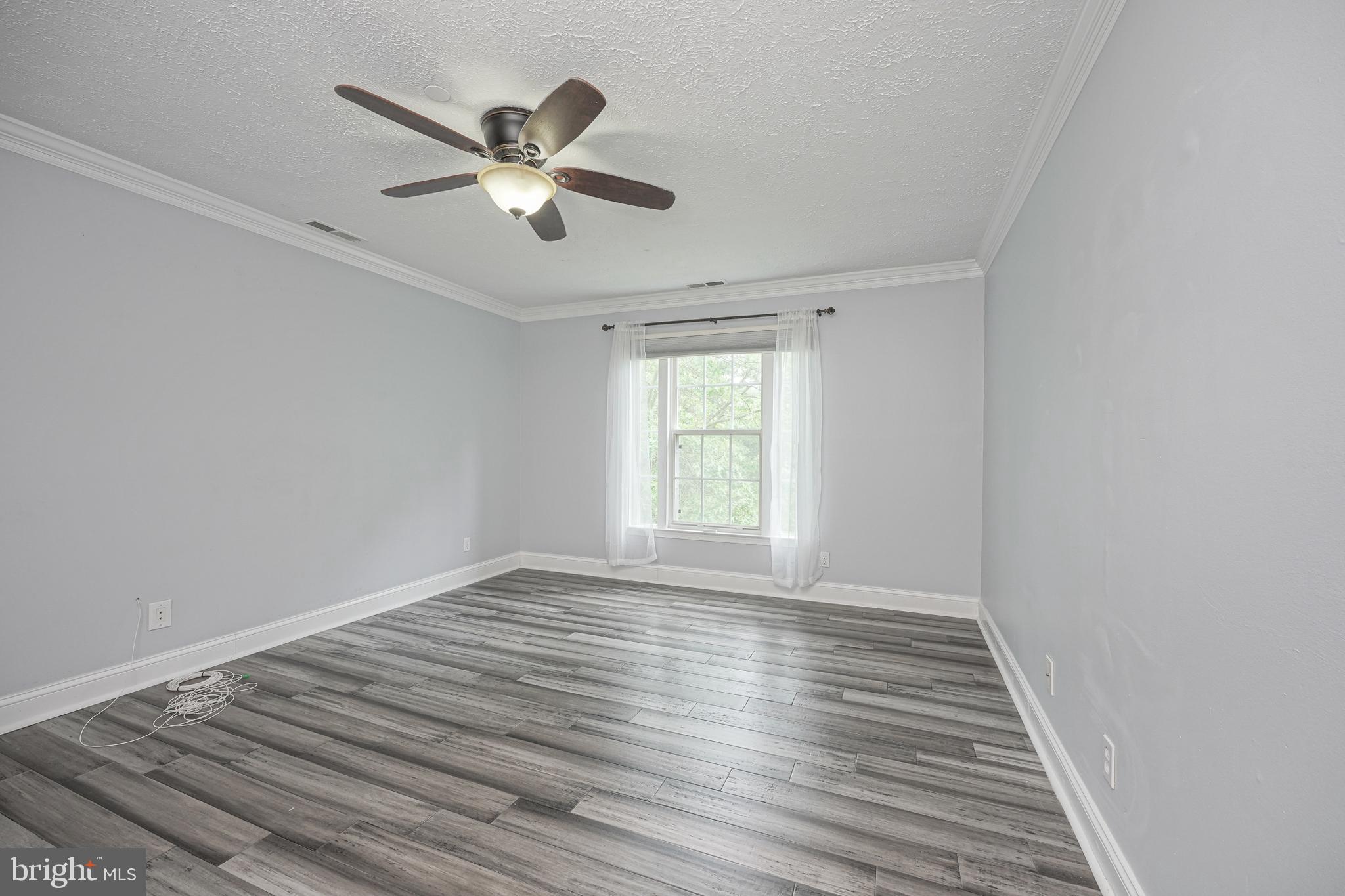 84 Eldon Way Marlton, NJ 08053 - Photo 16 of 27 wooden floor in an empty room with a window