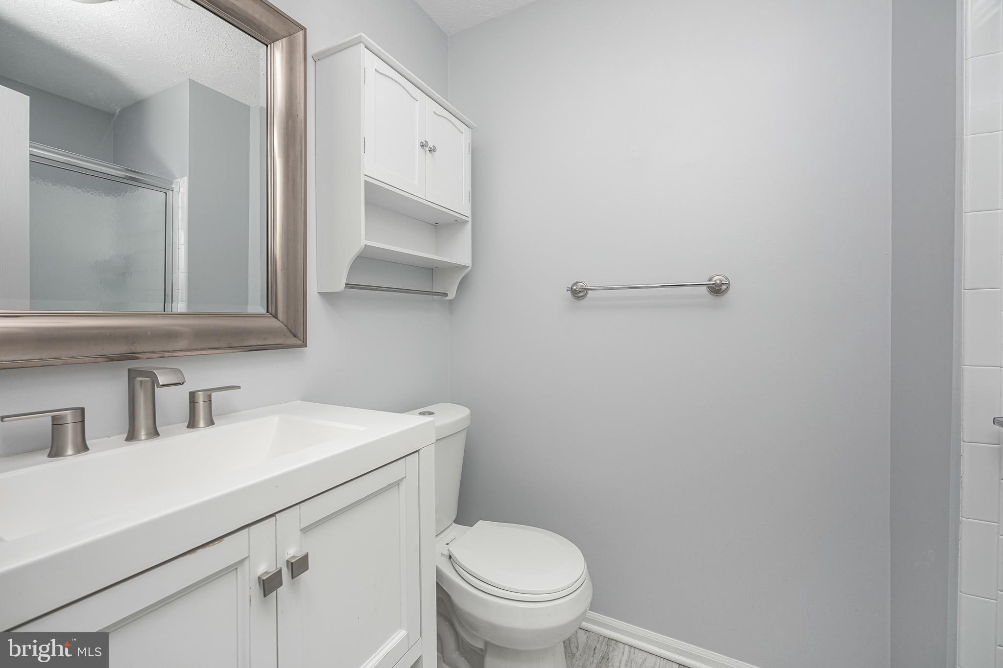 84 Eldon Way Marlton, NJ 08053 - Photo 18 of 27 a bathroom with a toilet sink and mirror