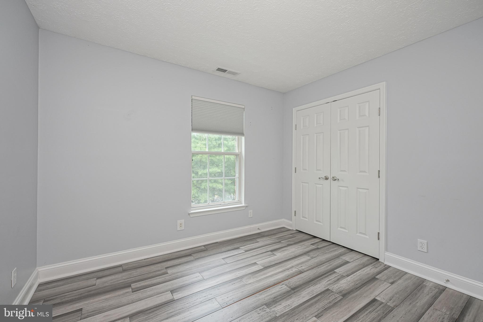 84 Eldon Way Marlton, NJ 08053 - Photo 21 of 27 an empty room with wooden floor and window