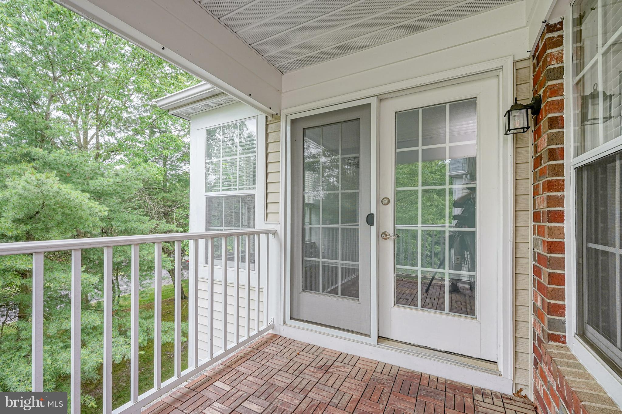 84 Eldon Way Marlton, NJ 08053 - Photo 26 of 27 a view of a balcony with a floor to ceiling window wooden floor and wooden fence