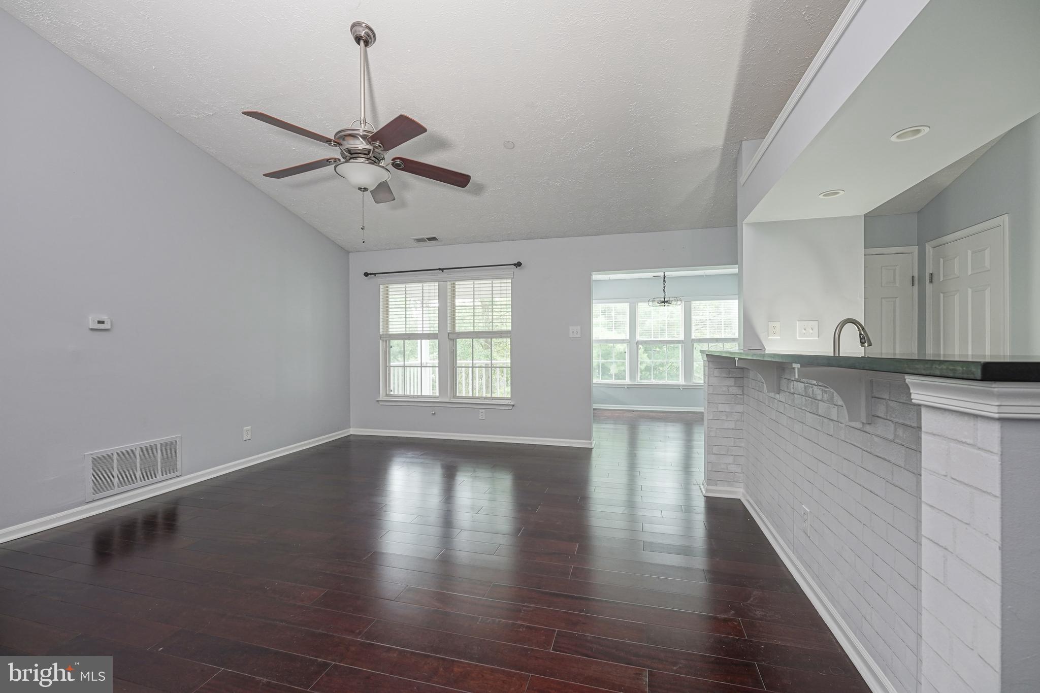 84 Eldon Way Marlton, NJ 08053 - Photo 9 of 27 a view of an empty room with window and wooden floor