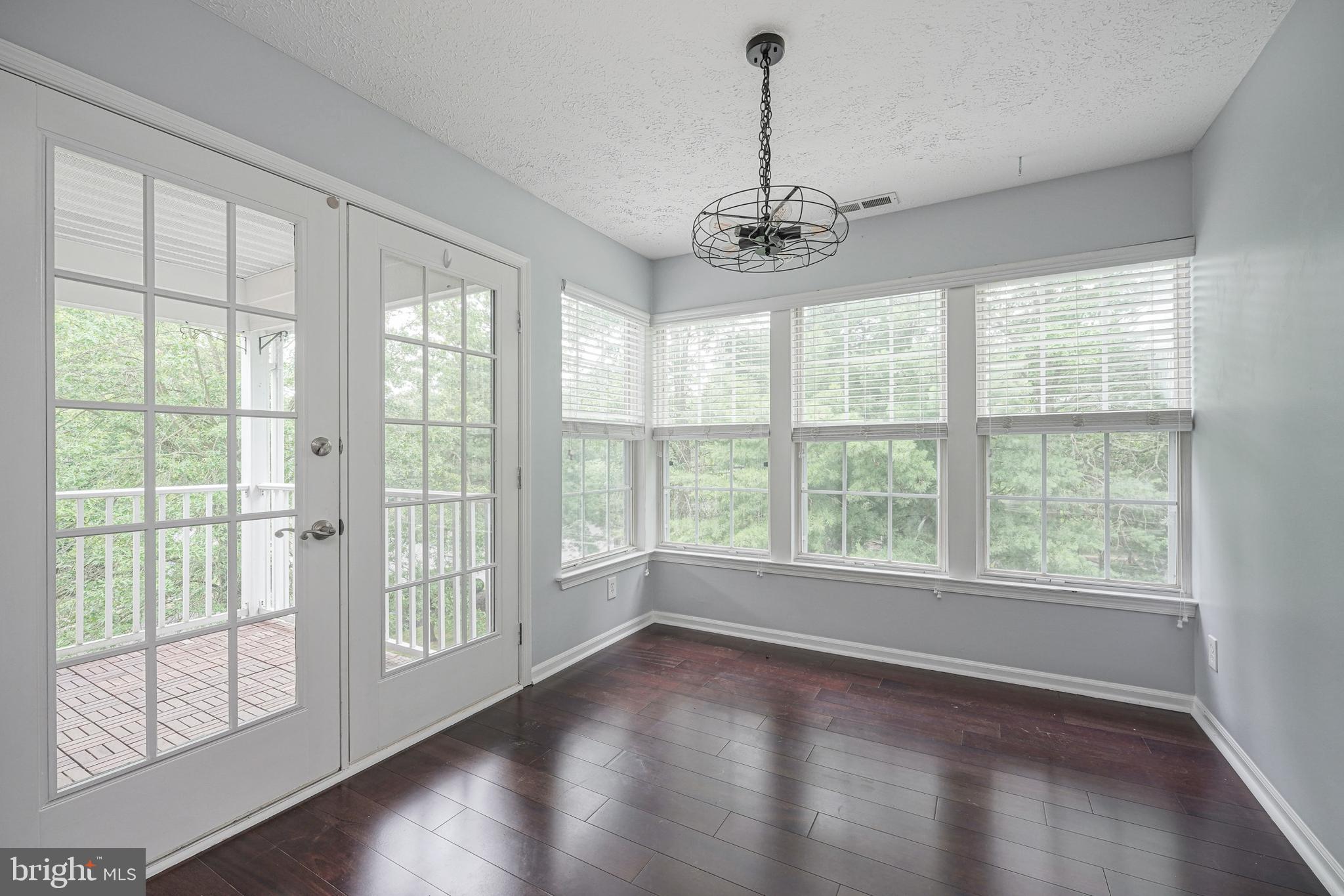 84 Eldon Way Marlton, NJ 08053 - Photo 10 of 27 a view of an empty room with wooden floor and a window
