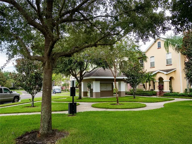 a view of a patio with a table chairs and a yard