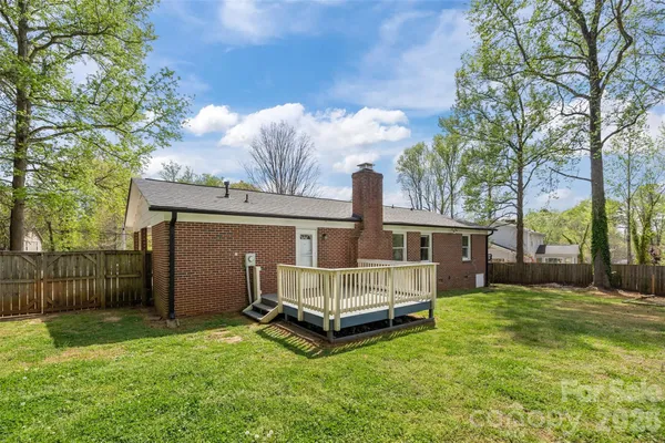 a view of backyard with a garden and deck