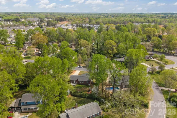 an aerial view of residential house with parking space and trees