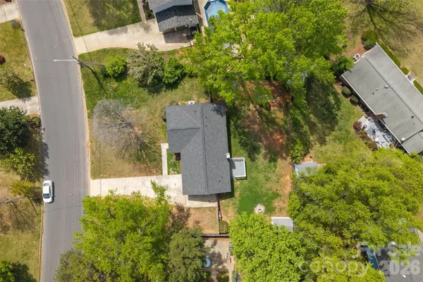 an aerial view of a house with a yard