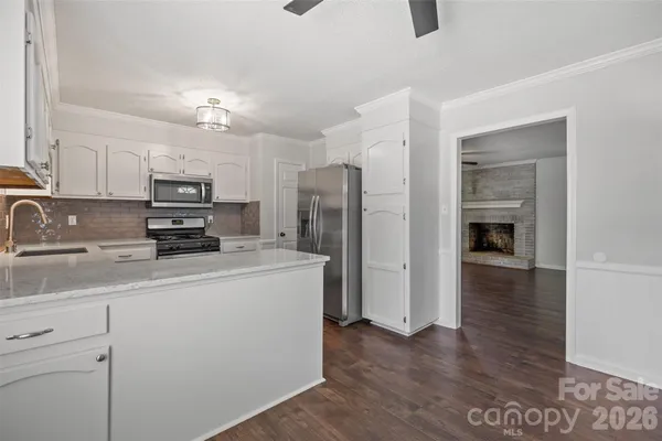 a kitchen with kitchen island a refrigerator sink and cabinets