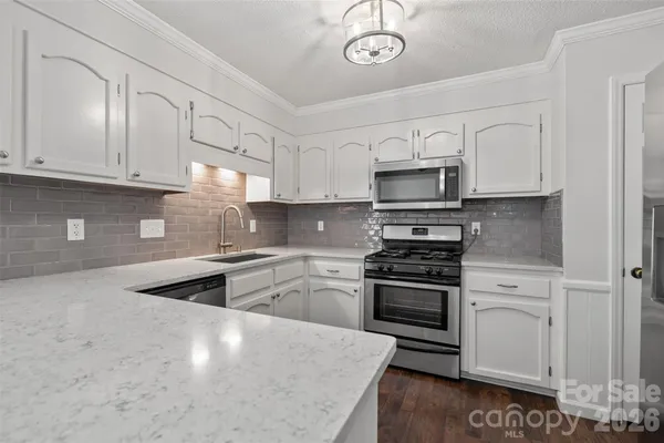 a kitchen with cabinets and stainless steel appliances