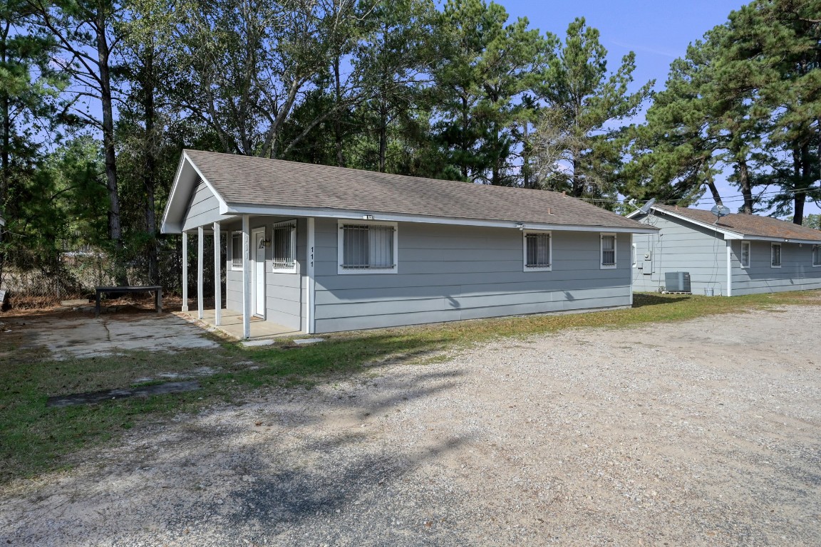 111 Cartwright Road Conroe, TX 77301 - Photo 3 of 19 a front view of a house with garden