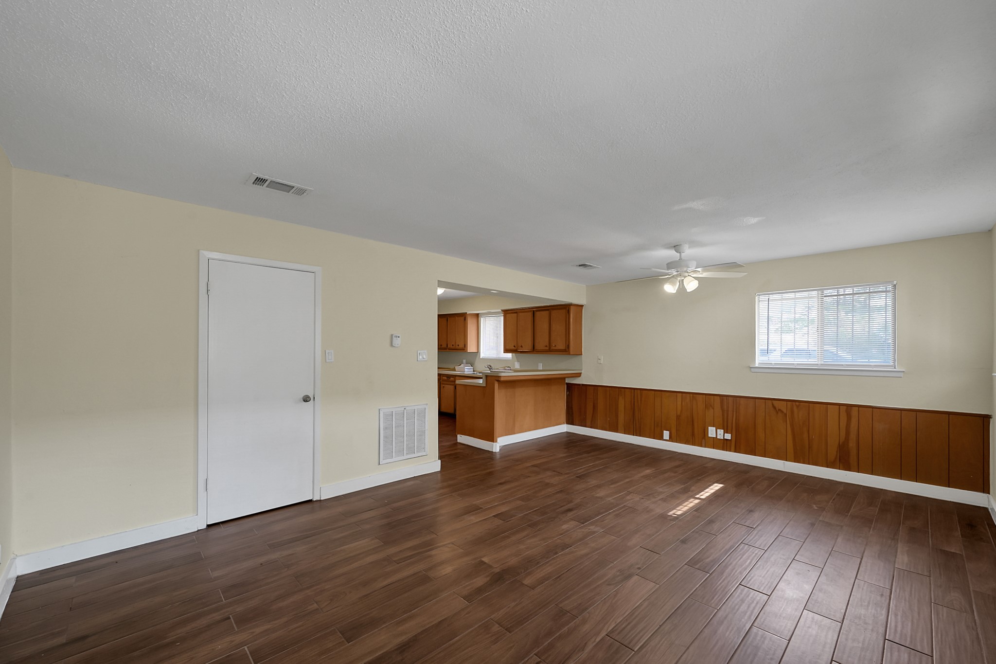 111 Cartwright Road Conroe, TX 77301 - Photo 7 of 19 an empty room with wooden floor and windows