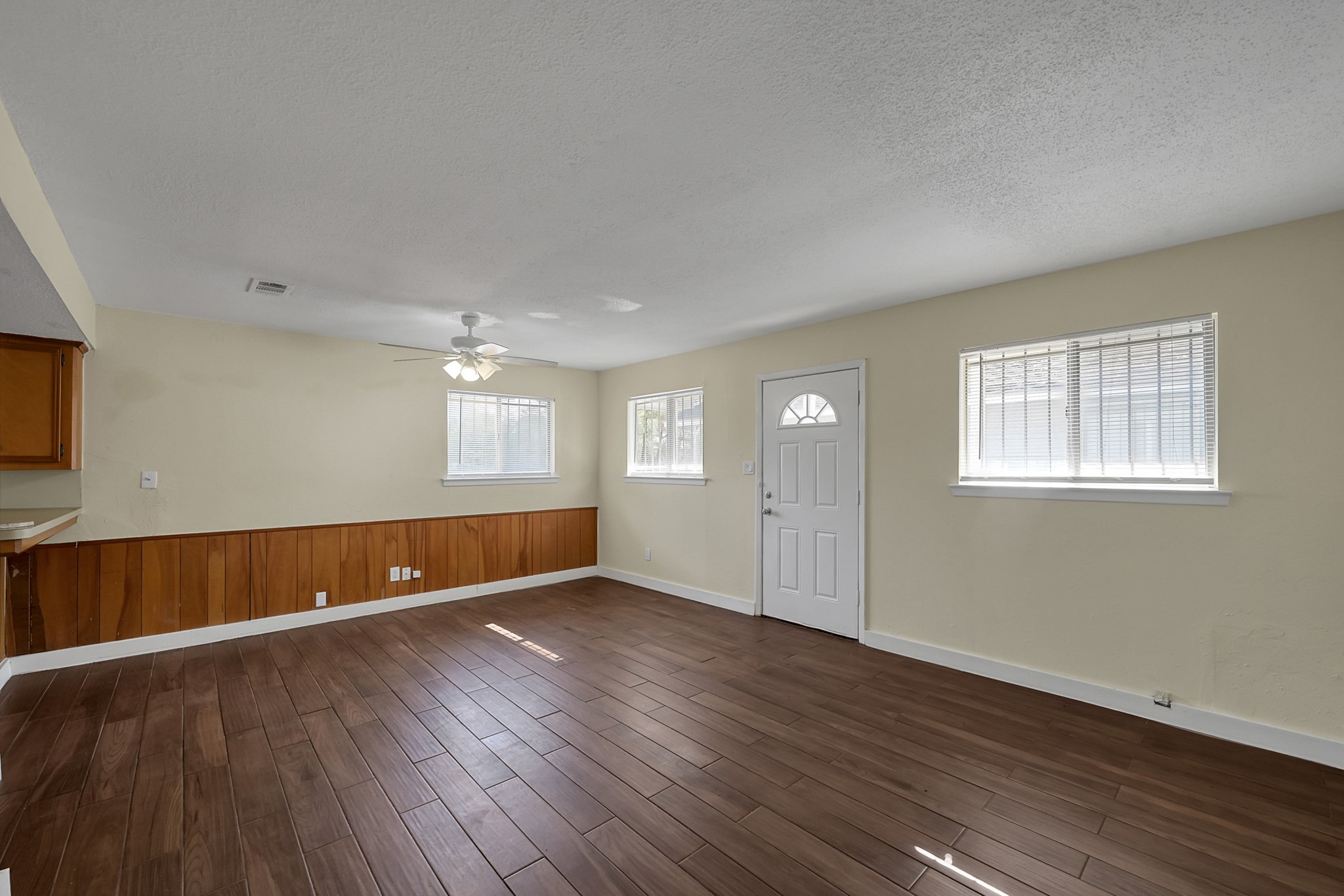111 Cartwright Road Conroe, TX 77301 - Photo 8 of 19 a view of an empty room with wooden floor and a window