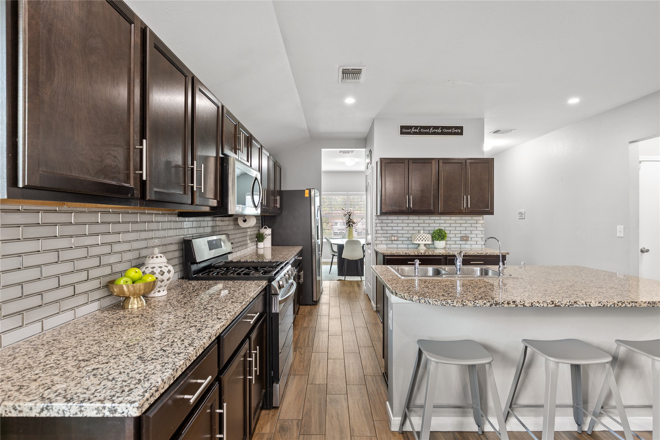 256 Alpha Kyle, TX 78640 - Photo 8 of 27 Granite counters and stainless steel appliances adorn this functional kitchen.