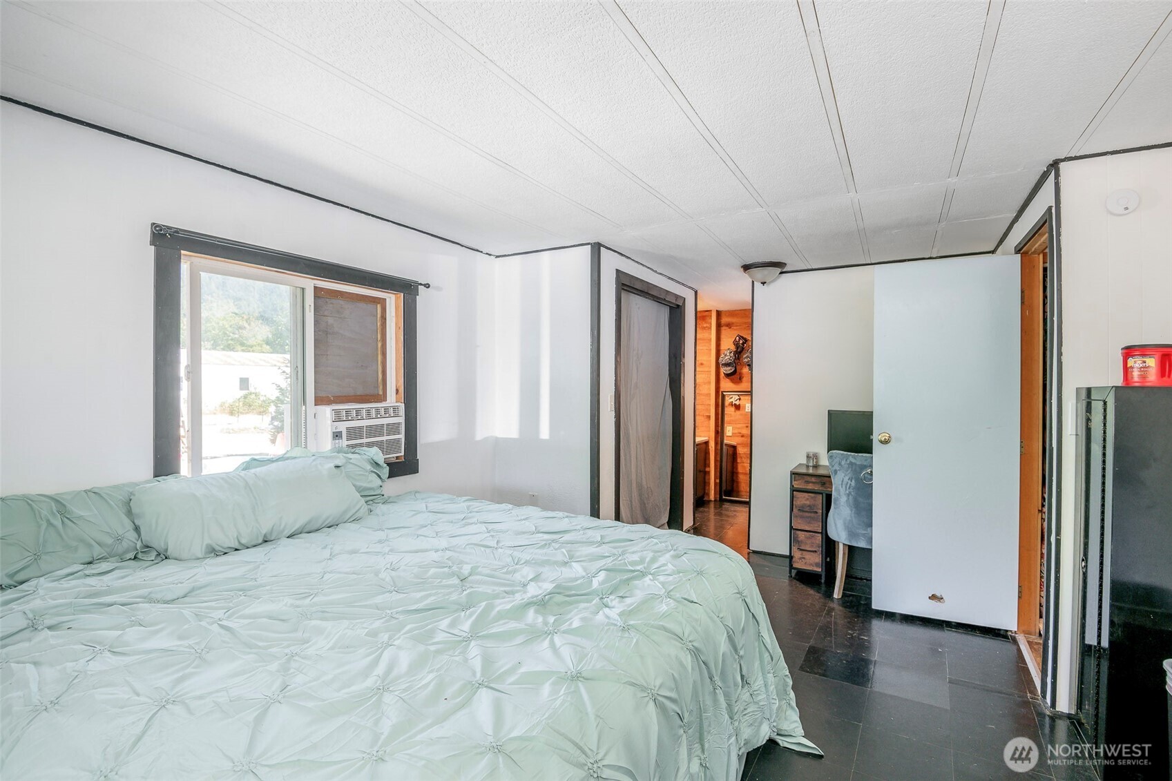 142 Gharet Road Randle, WA 98377 - Photo 18 of 32 a bedroom with a large bed and a chandelier