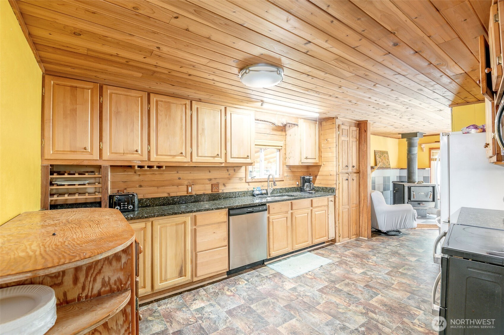 142 Gharet Road Randle, WA 98377 - Photo 6 of 32 a kitchen with a sink a stove top oven a chimney and a dining table chair