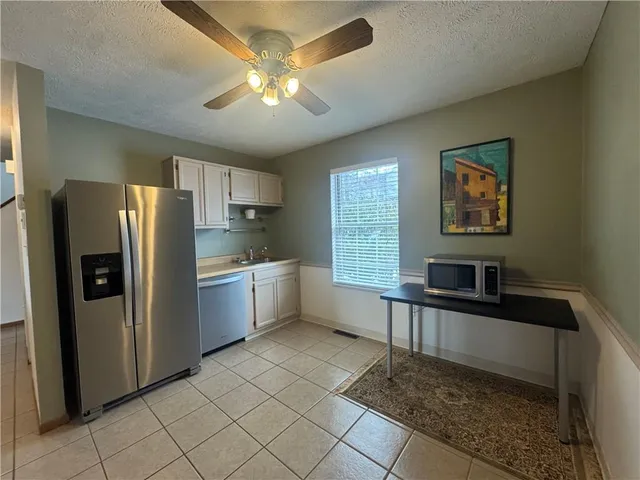 a kitchen with stainless steel appliances a refrigerator and a sink
