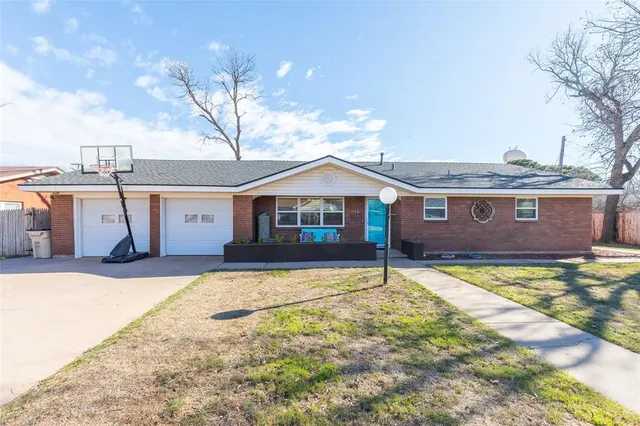 a front view of a house with yard and garage