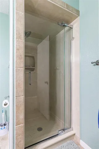a bathroom with a glass shower door