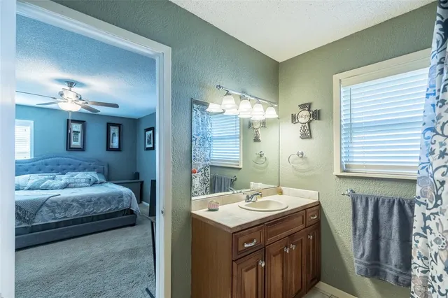 a en suite bathroom with a double vanity sink and a mirror
