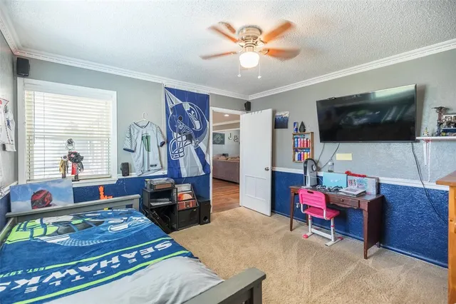 a bedroom with furniture and a flat screen tv