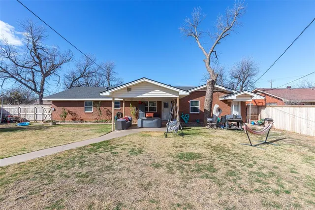 a view of a house with backyard porch and sitting area