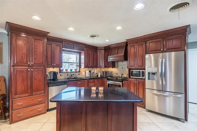 a kitchen with refrigerator and cabinets