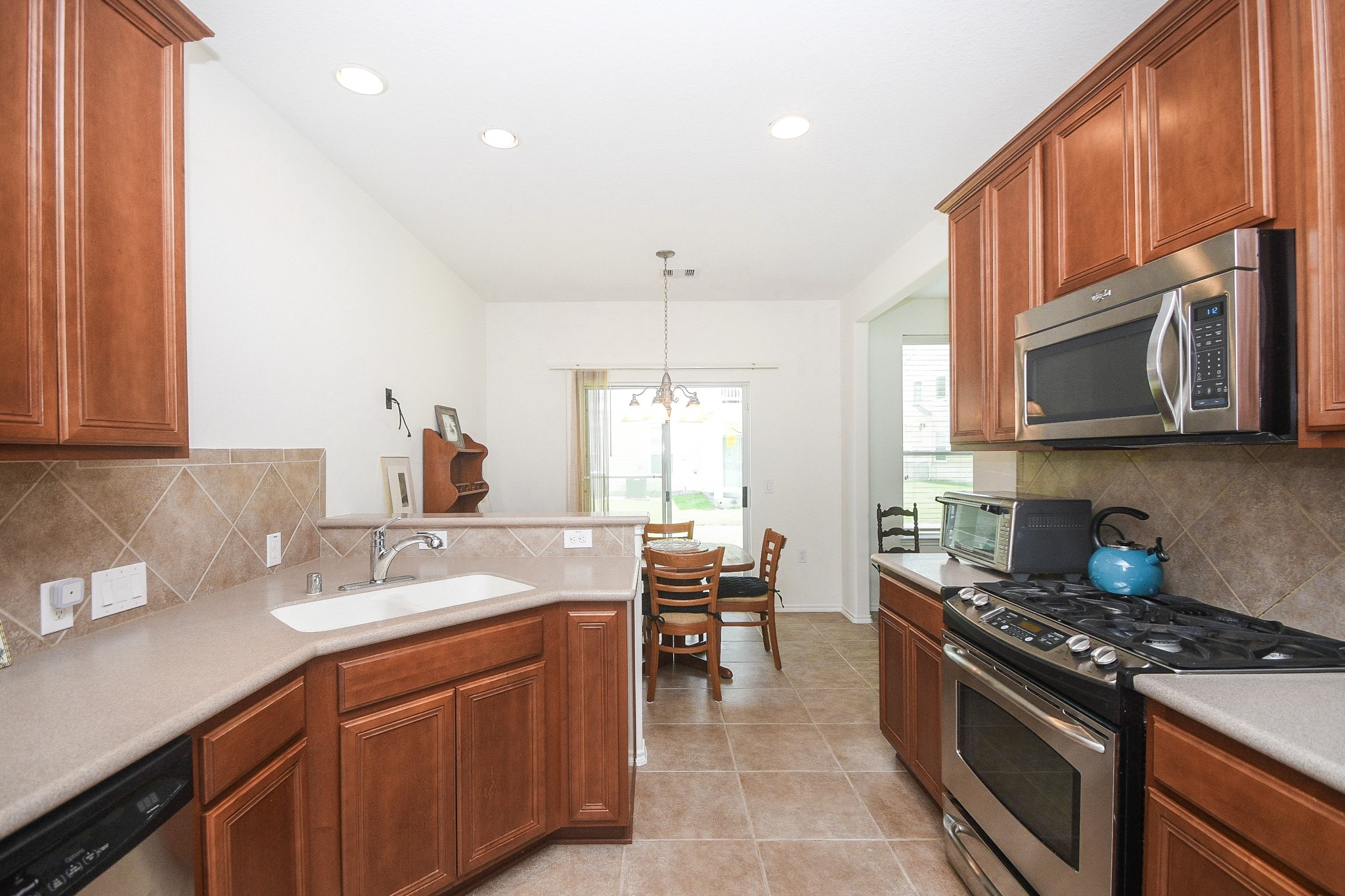 13600 Breton Ridge Street, Unit 36F Houston, TX 77070 - Photo 16 of 38 Kitchen seamlessly connected to the dining area for easy entertaining.