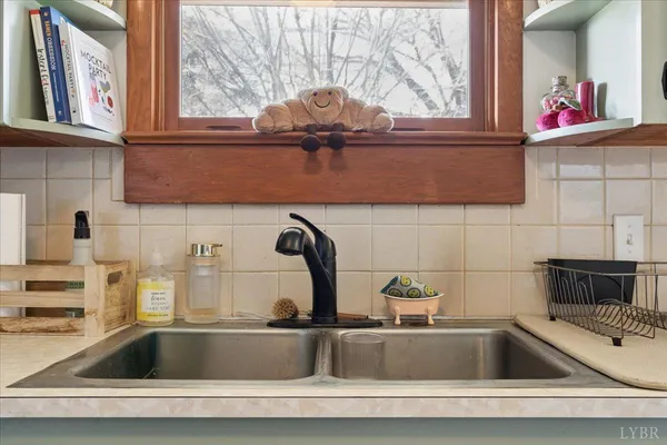 a kitchen with a sink and cabinet next to a window