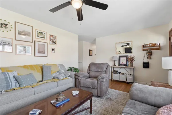 a living room with furniture and wooden floor