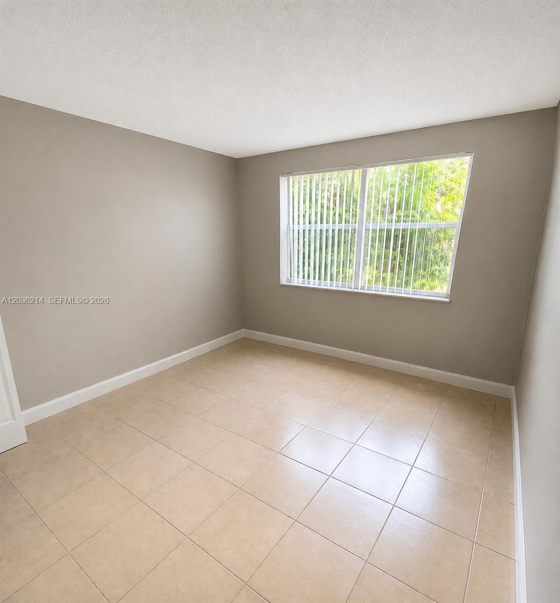 8741 Wiles Road, Unit 204 Coral Springs, FL 33067 - Photo 6 of 16 a view of an empty room with a window