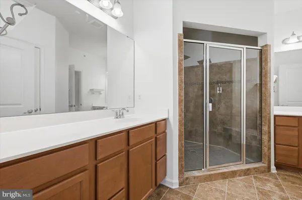 a bathroom with a shower sink and mirror
