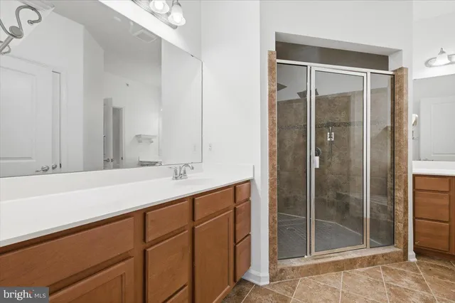 a bathroom with a shower sink and mirror