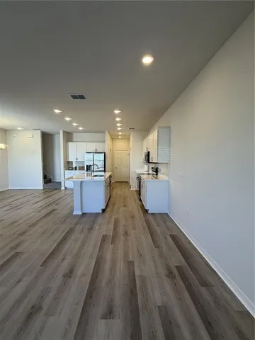 a bathroom with a granite countertop toilet and a sink