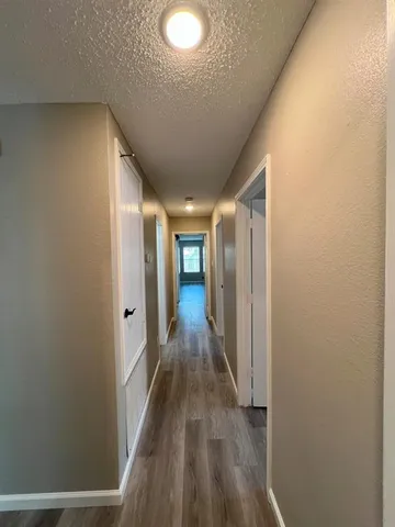 a view of hallway with wooden floor