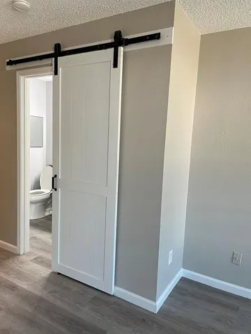 a view of bathroom with a shower and a toilet