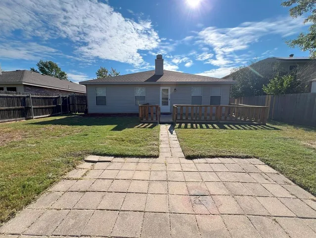 a view of a house with backyard porch and sitting area