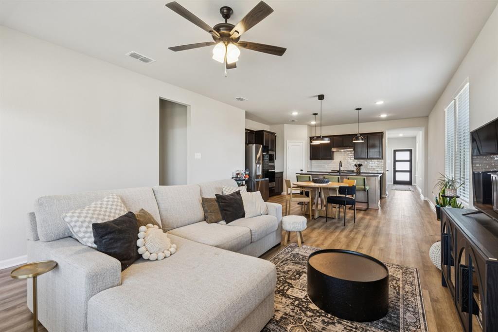 490 Tender Summit Lavon, TX 75166 - Photo 11 of 23 a living room with furniture a flat screen tv and kitchen view