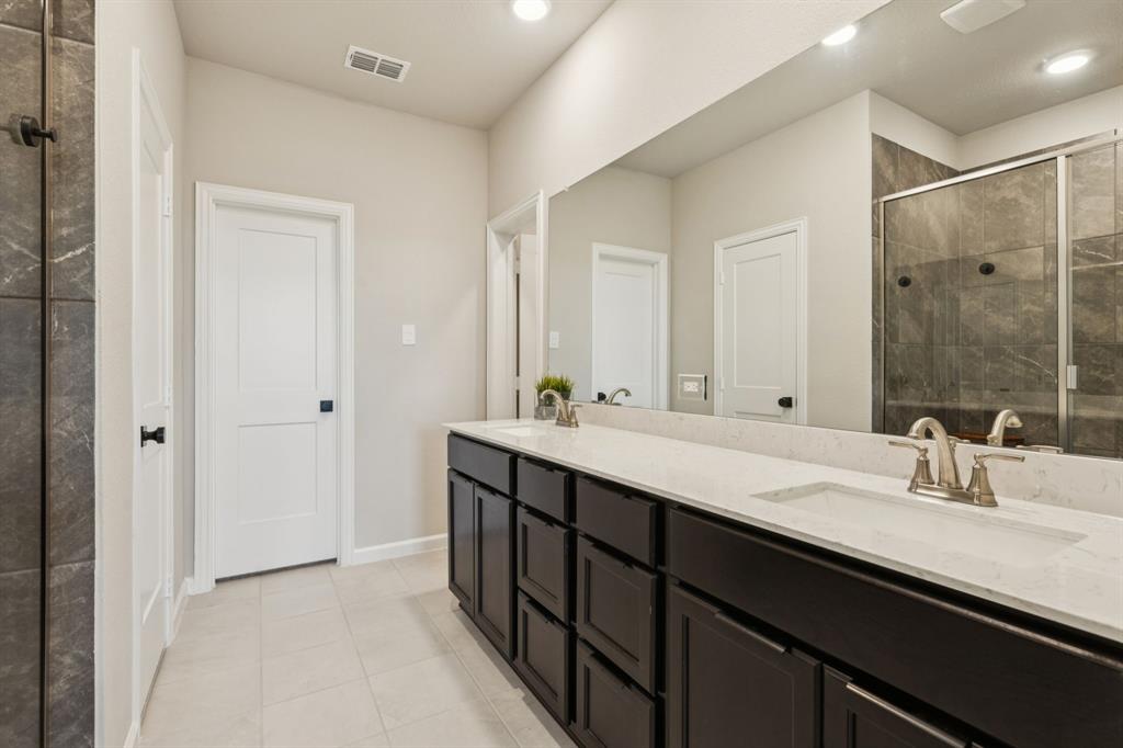 490 Tender Summit Lavon, TX 75166 - Photo 15 of 23 a bathroom with a double vanity sink a and mirror