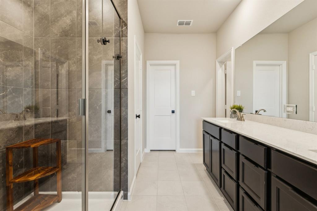 490 Tender Summit Lavon, TX 75166 - Photo 16 of 23 a bathroom with a double vanity sink and mirror