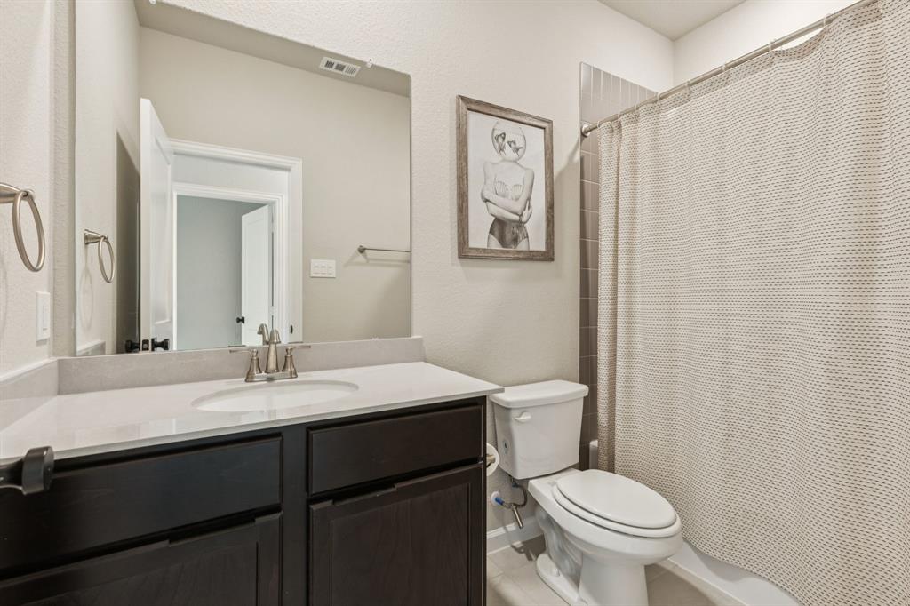 490 Tender Summit Lavon, TX 75166 - Photo 20 of 23 a bathroom with a granite countertop sink toilet and a mirror